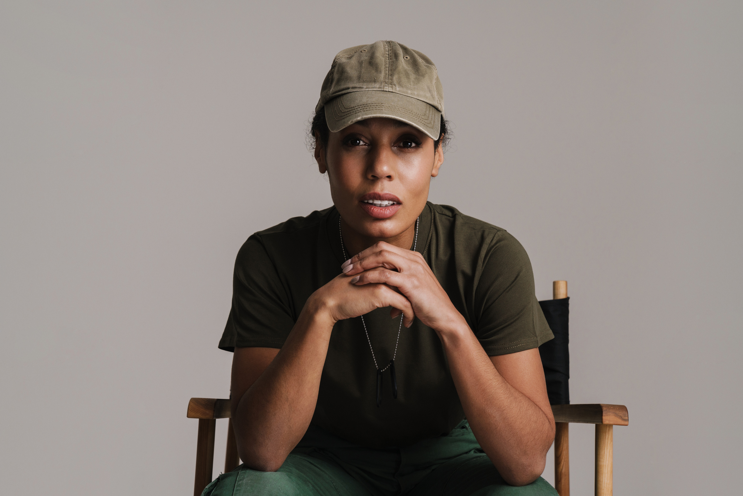 African American Soldier Woman Looking at Camera While Sitting on Chair